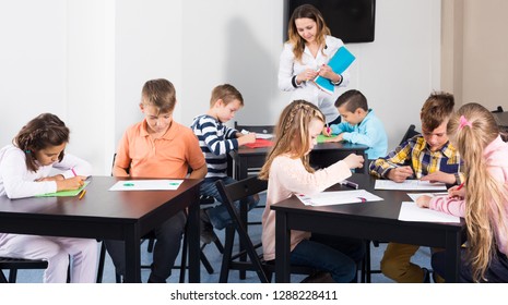 Children In Elementary Age Drawing At Classroom In School