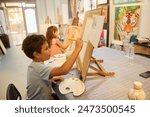 Children enjoying art class, painting and drawing with guidance from their teacher in a lively workshop. Engaged in creative activities, learning new artistic skills.