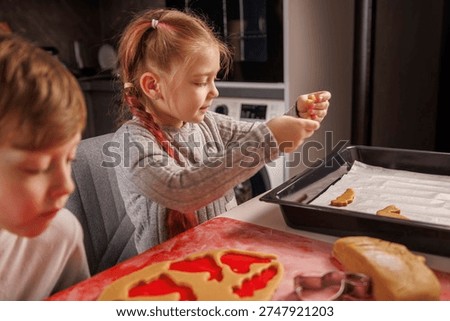 Children are enthusiastically preparing Easter cookies
