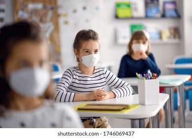 Children With Face Mask Back At School After Covid-19 Quarantine And Lockdown.