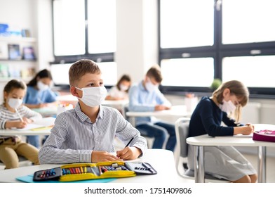 Children With Face Mask Back At School After Covid-19 Quarantine And Lockdown.