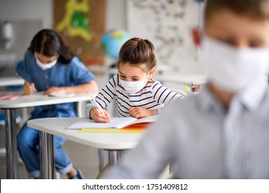 Children With Face Mask Back At School After Covid-19 Quarantine And Lockdown.