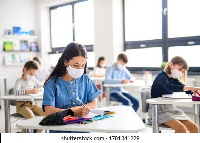 Children With Face Mask Back At School After Covid-19 Quarantine And Lockdown.