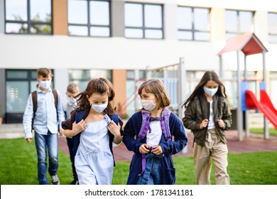 Children With Face Mask Going Back To School After Covid-19 Lockdown, Walking Outdoors.