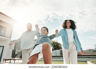 Children, family and a boy swinging with his parents outdoor in the garden of their home together. Kids, love or playing with a mother, father and son having fun while bonding in the backyard - Powered by Shutterstock