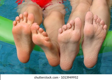 Children Feet In A Swimming Pool