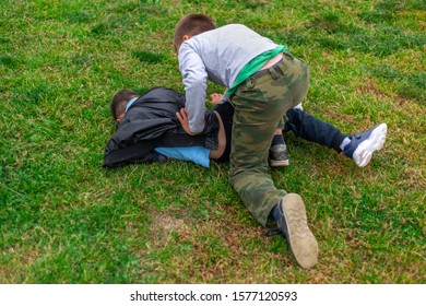 Children Fight. Conflict Of Teens On The Playground.