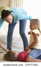 Children Fighting In Front Of Mother At Home