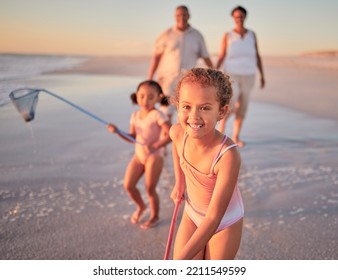 Children, Fishing And Family With A Girl At The Beach With Her Grandparents And Sister For Summer Holiday. Kids, Happy And Ocean With A Child On Sand By The Sea With Her Grandmother And Grandfather