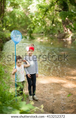  Children fishing in the river with a net