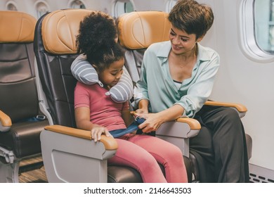 Children in flight cabin fasten seat belt for safety travel holiday vacation with mother