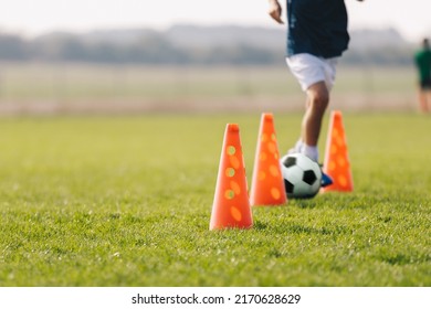 Children Football Player With Training Cones. Soccer Agility Training Equipment. Kids Playing Sports On Grass Field. Happy Boys Practice Sports. Kids Football Speed Training Drill