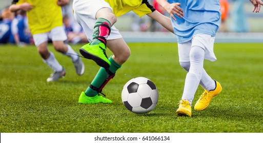 Children Football Players Running After the Ball. Kids Sport Duel. Running Youth Soccer Football Players. Boys Kicking Soccer Match