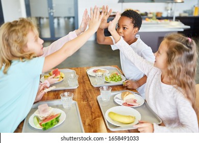 Children As Friends Have Fun In The School Canteen At Lunch