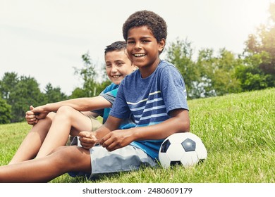 Children, friends and sitting in field with soccer ball for happiness, development or bonding together in outdoor park. Boys, nature and young kids with smile for freedom, support or relax on weekend - Powered by Shutterstock