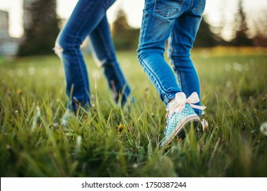 Children friends walking on meadow. Closeup of kids legs in jeans on grass. Outdoor fun summer seasonal children activity. Friends having fun together. Happy childhood lifestyle. - Shutterstock ID 1750387244