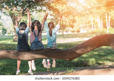 Children Friendship Concept With Happy Girl Kids In The Park Having Fun Sitting Under Tree Playing Together Enjoying Good Memory And Moment Of Student Friend Lifestyle In School Summer Time Day Joy