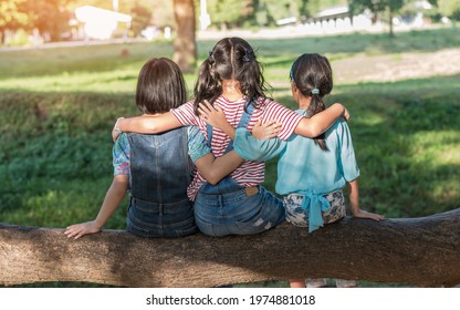 Children Friendship Concept With Happy Girl Kids In The Park Having Fun Sitting Under Tree Shade Playing Together Enjoying Good Memory And Moment Of Student Lifestyle With Friends In School Time Day