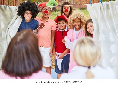 Children In Funny Disguise As A Theater Group At The Talent Show At The Holiday Camp