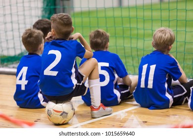 Children Futsal Team. Group Of Young Indoor Soccer Players Sitting Together. Kids School Football Tournament
