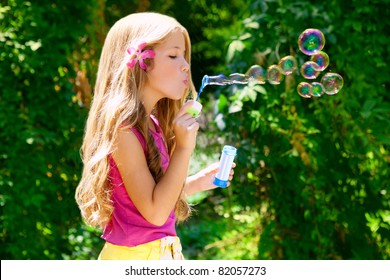 Children Girl Blowing Soap Bubbles In Outdoor Forest