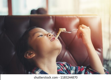 Children Girl Enjoy Eating Cheese From Pizza. Asian Kid People Enjoying To Eating Cheese Extend. Etiquette Food And Drink Concept 