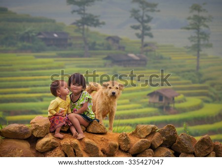 Children girl smile and dog of rice terraces background ,Tu Lu Yen Bai, Vietnam.
