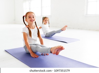 children girls doing yoga and gymnastics in the gym
 - Powered by Shutterstock