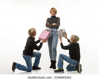 Children Give A Gift To Mom While Kneeling