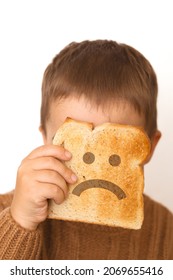 Children And Gluten. Preschool Boy With Toasted Bread, With Sad Emoji. Gluten Intolerance By Kids.