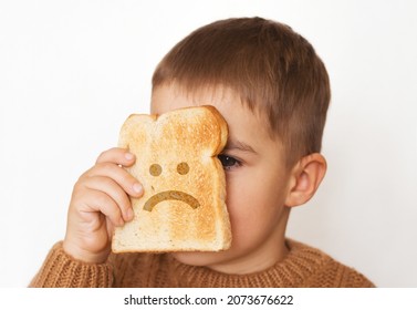 Children And Gluten. Preschool Boy With Toasted Bread, With Sad Emoji. Gluten Intolerance By Kids.