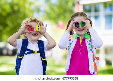 Children Go Back To School. Start Of New School Year After Summer Vacation. Boy And Girl With Backpack And Books On First School Day. Beginning Of Class. Education For Kindergarten And Preschool Kids.