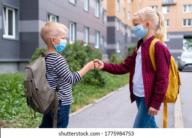 Children Greeting. Kids Wearing Mask And Backpacks Protect And Safety Coronavirus For Back To School. Bou And Girl Going School After Pandemic Over