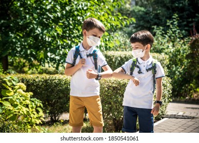 Children Greeting. Kids Wearing Mask And Backpacks Protect And Safety Coronavirus For Back To School. Bou And Girl Going School After Pandemic Over.