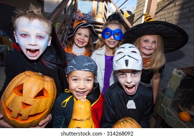 Children In Halloween Costumes Show Funny Faces