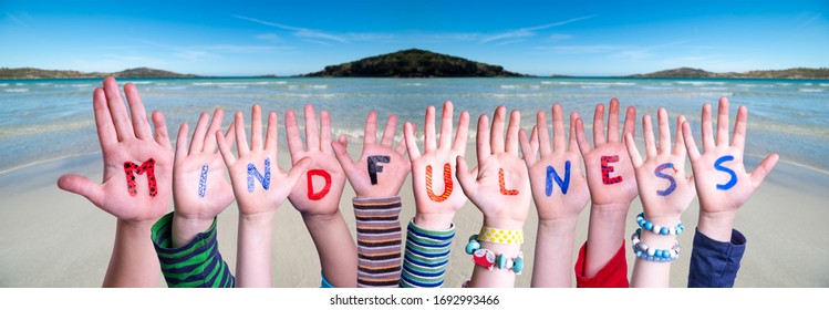 Children Hands Building Word Mindfulness, Ocean Background - Powered by Shutterstock