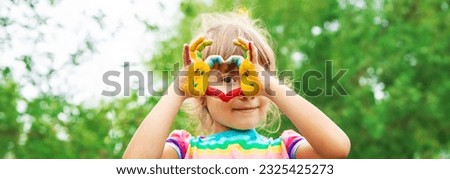 children hands in colors. Summer photo. Selective focus. nature