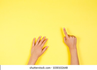 Children hands pointing on yellow background - Powered by Shutterstock