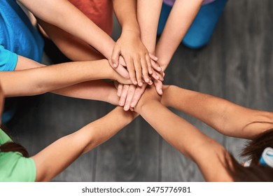 Children, hands and together for solidarity, support and achievement for growth in education. Students, kids and school for teamwork, success and development with huddle for commitment by above - Powered by Shutterstock