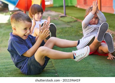 Children have fun doing children's gymnastics or aerobics in physical education class in elementary school