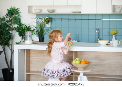  Children Having Fresh Fruit. Child Eating Breakfast. Kids Eat Fruits In A White Kitchen