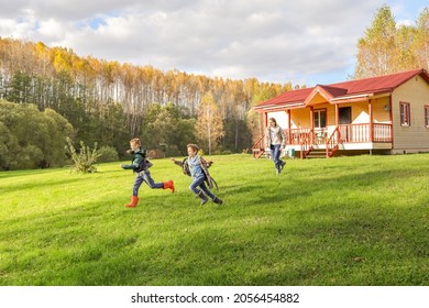 Children are having fun frolicking on the lawn. They run after each other and laugh.