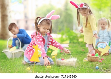 Children having fun in park. Easter egg hunt concept - Shutterstock ID 717145540