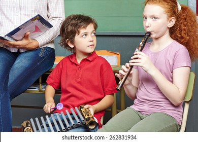 Children Having Music Lessons In Elementary School Class