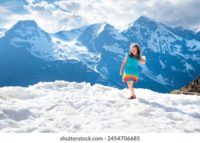 Children hiking in Alps mountains, Austria. Kids play at snow covered mountain peak on warm sunny spring day. Snow ball fight. Summer family vacation. Little girl on hike trail to top. Outdoor fun.


 - Powered by Shutterstock