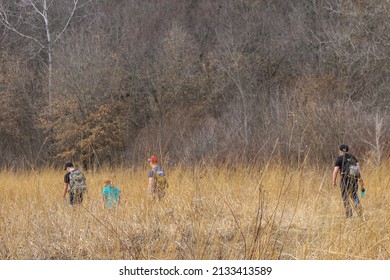 Children Hiking Through Tall Prairie Grass