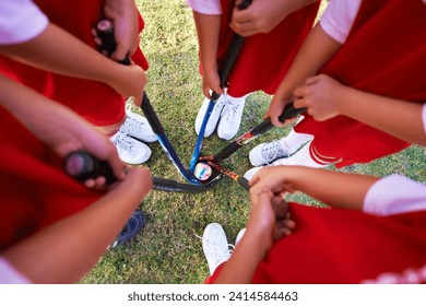 Children, hockey team and circle above with ball on green grass for sports, match or game together. Top view closeup of kids, player hands and huddle on field for teamwork or outdoor unity in nature - Powered by Shutterstock