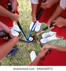 Children, hockey team and huddle above with ball on green grass for sports, match or game together. Top view closeup of kids, player hands and sticks on field for teamwork or outdoor unity in nature - Powered by Shutterstock