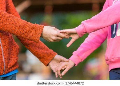 Children hold hands. Boy and Girl hold each other's hands. Children's hands together on a blurred background. Brother and sister. True friendship and love - Shutterstock ID 1746444872