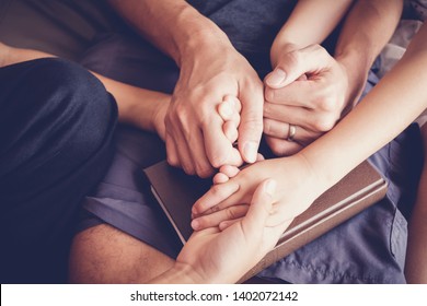 children holding hands and praying with their parent at home, family online worship Having faith and hope, World Day of Prayer,international day of prayer, trust, hope, gratitude, concept